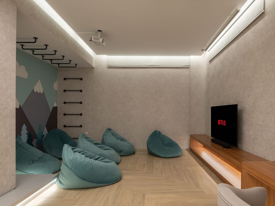 LG 65’’ Smart TV with PS5, seating area with bean bag chairs and a wall-climbing installation!