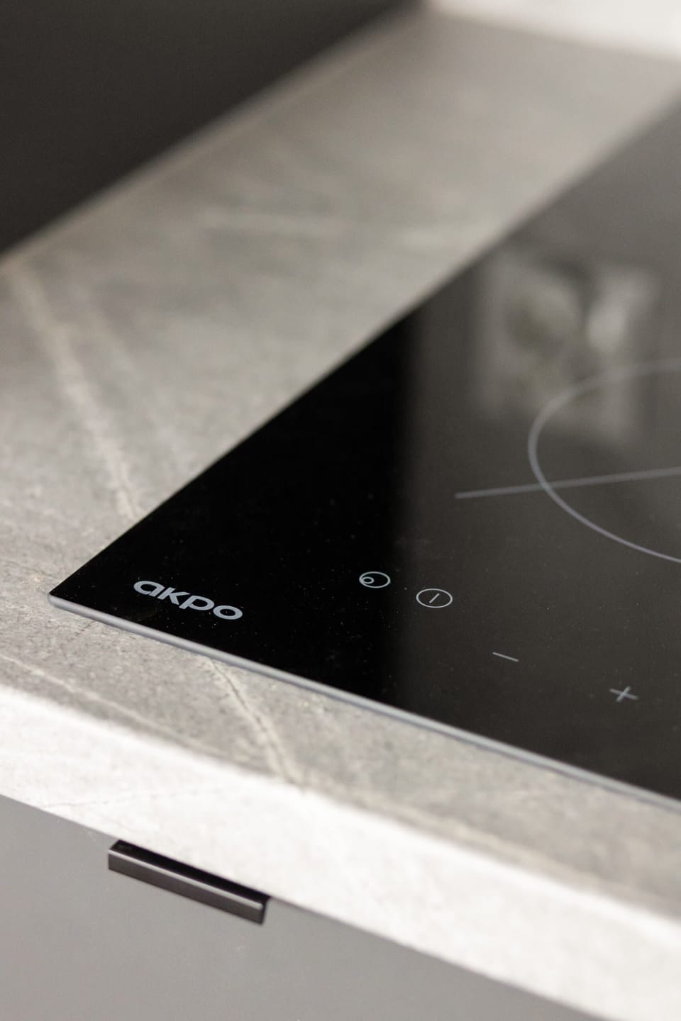 A close-up of a stovetop embedded into the counter for a seamless kitchen design.
