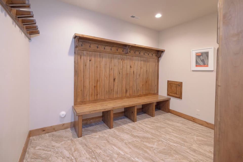 Your own private mudroom awaits with custom built-in storage and seating—perfect for organizing gear after mountain adventures or ski days.