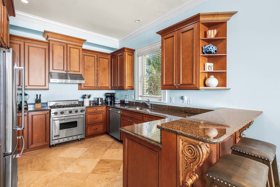 Second Floor Fully Stocked Kitchen with Granite Countertops, Stainless Steel Appliances including Viking Range, KitchenAid Refrigerator, and Under-Counter Ice Maker.