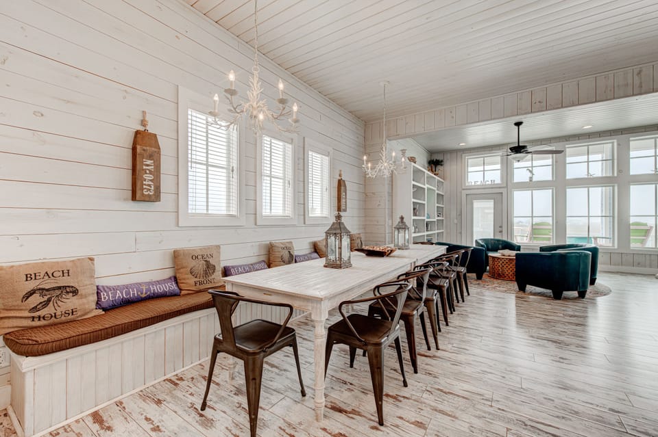 Gather around your stunning farmhouse dining table where coastal charm meets modern comfort in this bright, open living space.