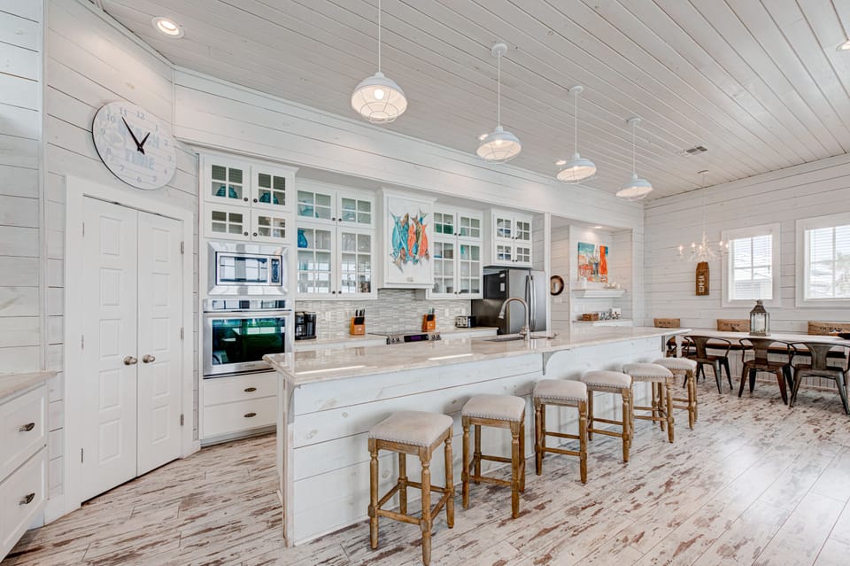 Your spacious coastal kitchen awaits with gleaming countertops, modern appliances, and a breakfast bar where you'll savor morning coffee.