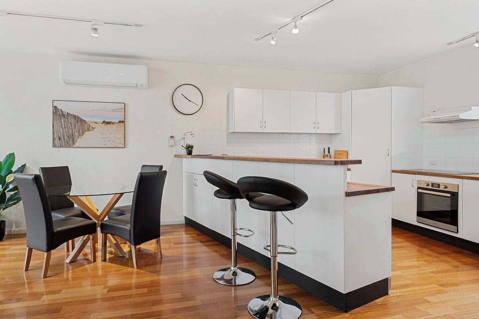 Adjacent to the kitchen is a four-seater table for enjoying meals at home.