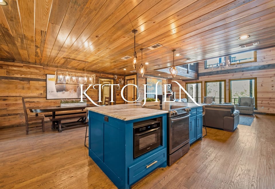 This kitchen showcases a striking blue island as its centerpiece, surrounded by wooden cabinetry and sleek appliances