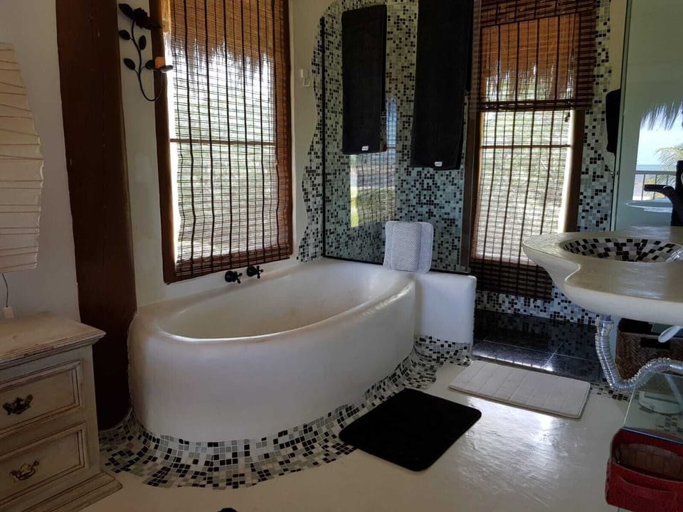 Suite, Ocean View | Bathroom | Shower, hydromassage showerhead, free toiletries, hair dryer