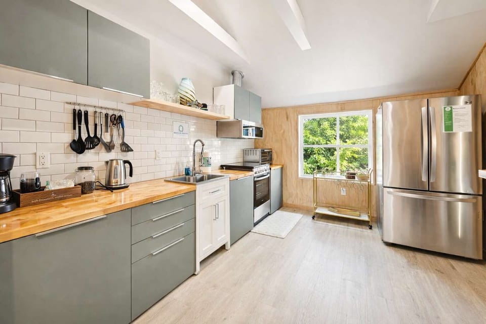 Fully Equipped Kitchen with Large Fridge, Oven, and Clean Modern Design