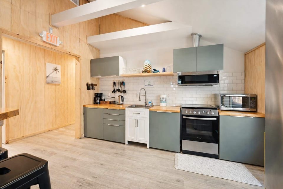 Light-Filled Kitchen with Stainless Steel Appliances & Wood Counters