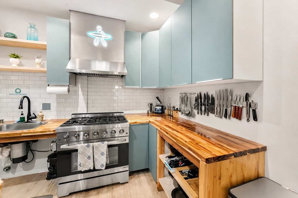 Bright Modern Kitchen with Gas Range and Wood Countertops — Practical Layout for Cooking, Prep, and Shared Use