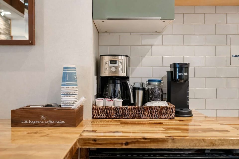 Coffee & Beverage Station with Countertop Setup, Coffee Maker, and Essentials — A Convenient In-Room Refreshment Area Designed for Easy Mornings and Relaxed Breaks