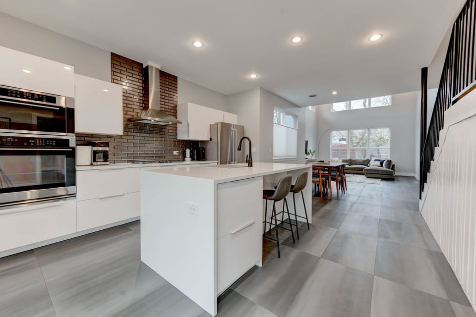 sleek and modern kitchen oozes luxury, boasting an island bar 