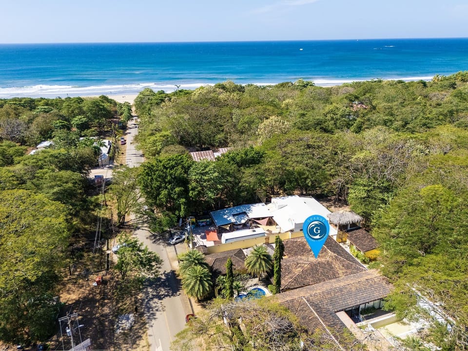 Blue pin shows the house location and distance to the beach just a short walk down the road.