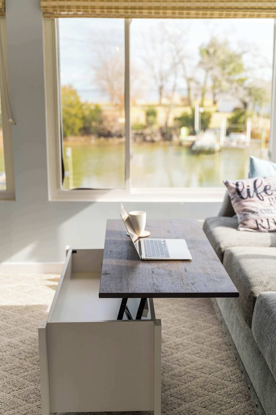 Off the dining area is the sunporch. It's arguably the best room in the house. Close off the doors and claim it for yourself when you WFH, we love the coffee table that converts to a laptop desk. Try not to get distracted by the view!