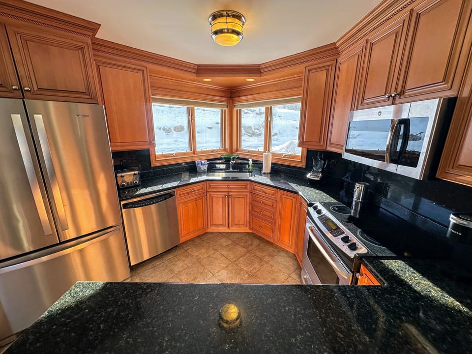 The fully stocked kitchen with granite countertops and stainless steel appliances has everything you need to prepare meals with ease.