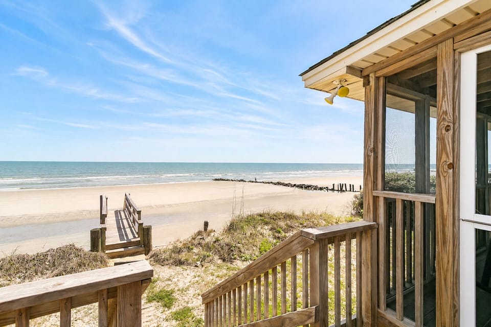 Walkway off the screened in porch towards the private beach walkway.