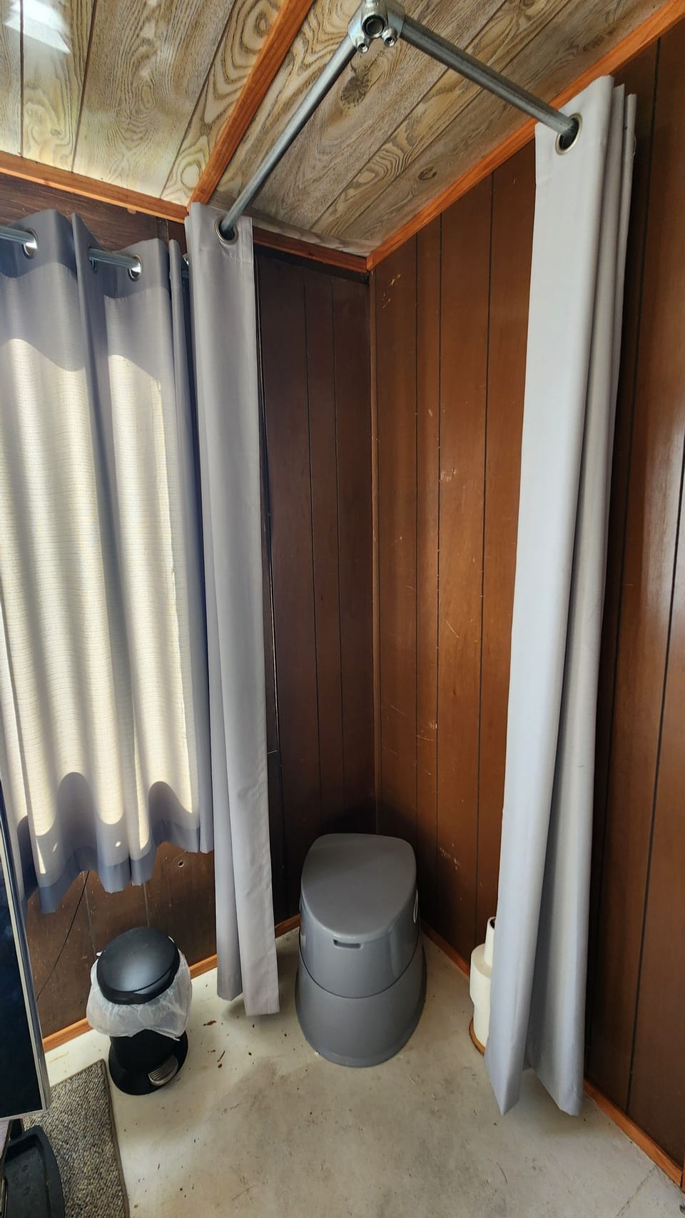 Wag Bag toilet system. put used bags on the porch in the screw top 5 gallon bucket. wag bags in the end table under the TV