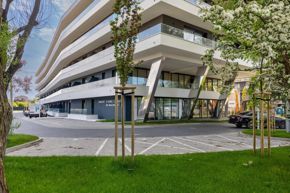 Exterior view of a modern residential building surrounded by greenery.
