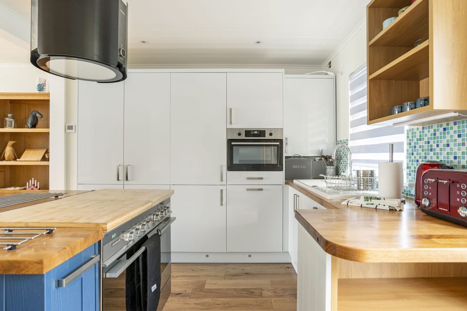 Kitchen w fridge, oven, dishwasher and storage