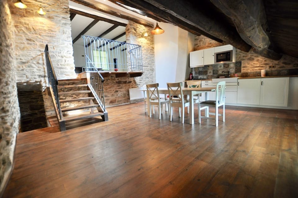 Fully integrated kitchen with dishwasher, washing machine, gas hob, electric oven, microwave and table for six