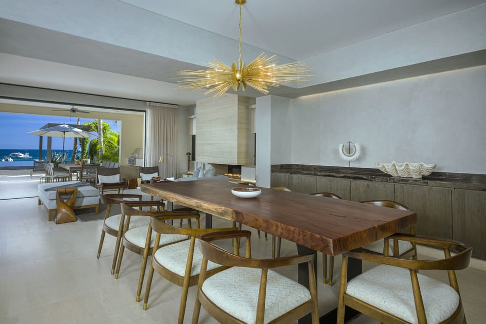 Dining room with a live-edge table seating ten and ocean views at Villa Marena in Hacienda Beach, Cabo San Lucas.