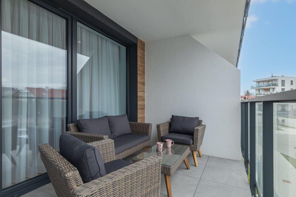 A balcony with a wicker seating set, offering a relaxing outdoor space.
