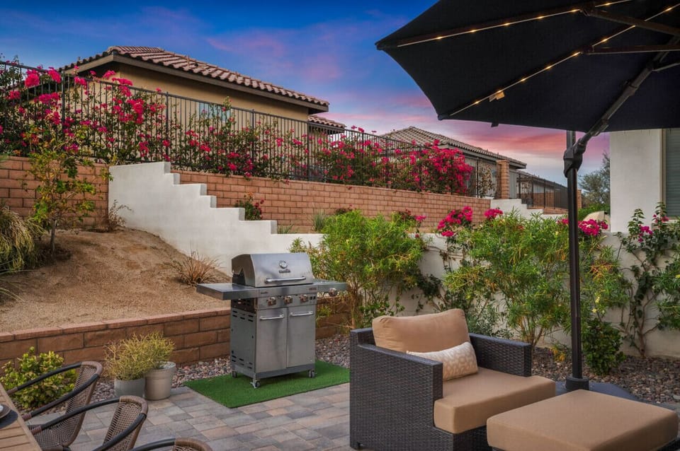 Lush garden pathway w/ blooming flowers & seating for a peaceful stroll