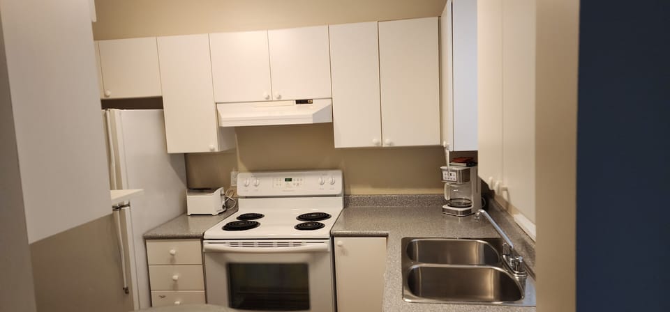 One Bedroom King | Private kitchen | Full-size fridge, microwave, oven, stovetop