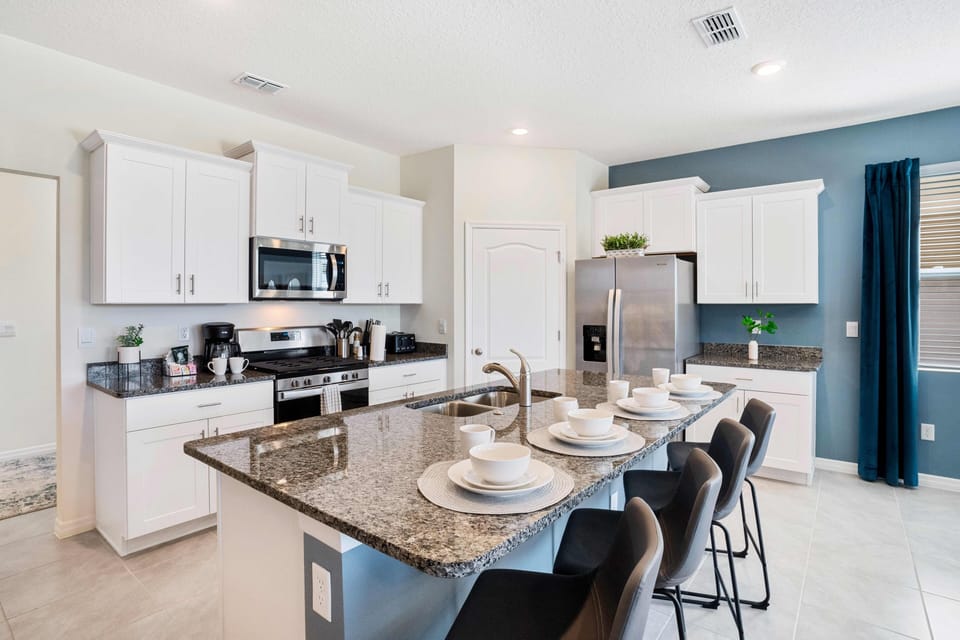 Sleek kitchen of the home in Davenport Florida - Fully equipped - Breakfast bar and high chairs - Harmonious blend of practicality and contemporary aesthetics