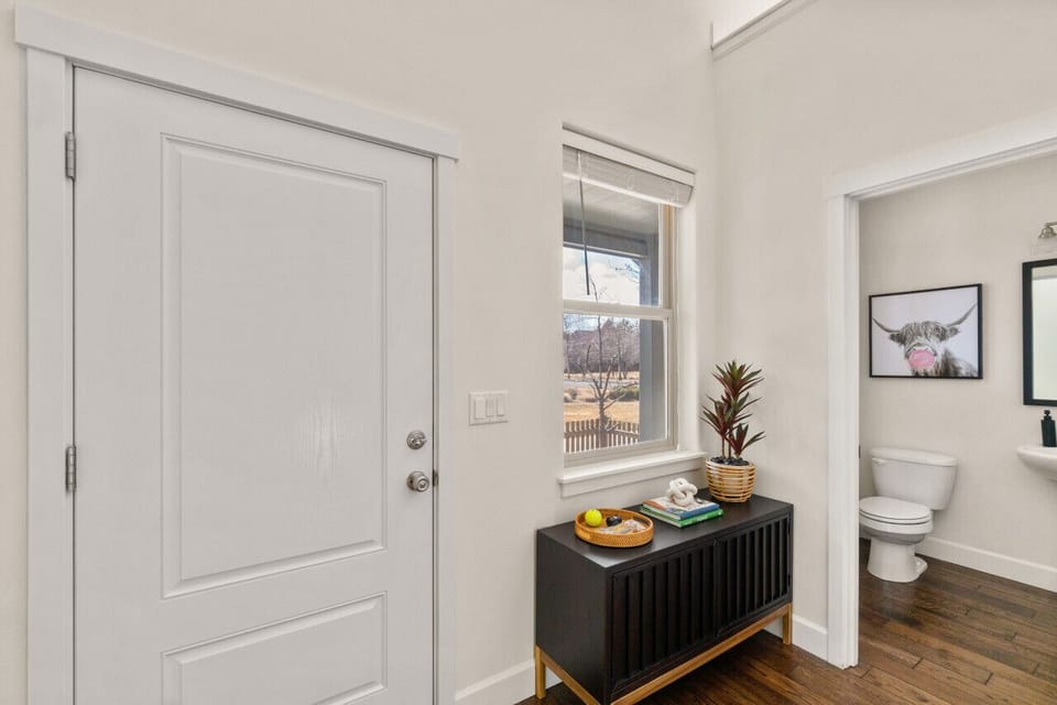 Entryway with half bath for guests.