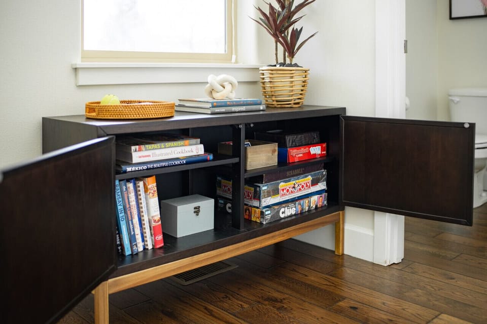 Game nights will be a blast with lots of choices to entertain the whole family. The console is also filled with cookbooks.