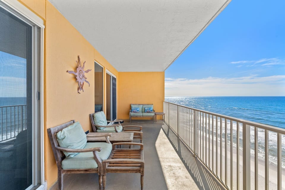 Relax on the spacious balcony with ocean views and comfortable seating.