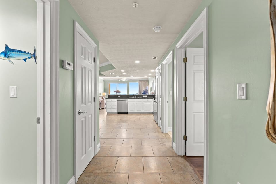 hallway leading to a modern kitchen with ocean views
