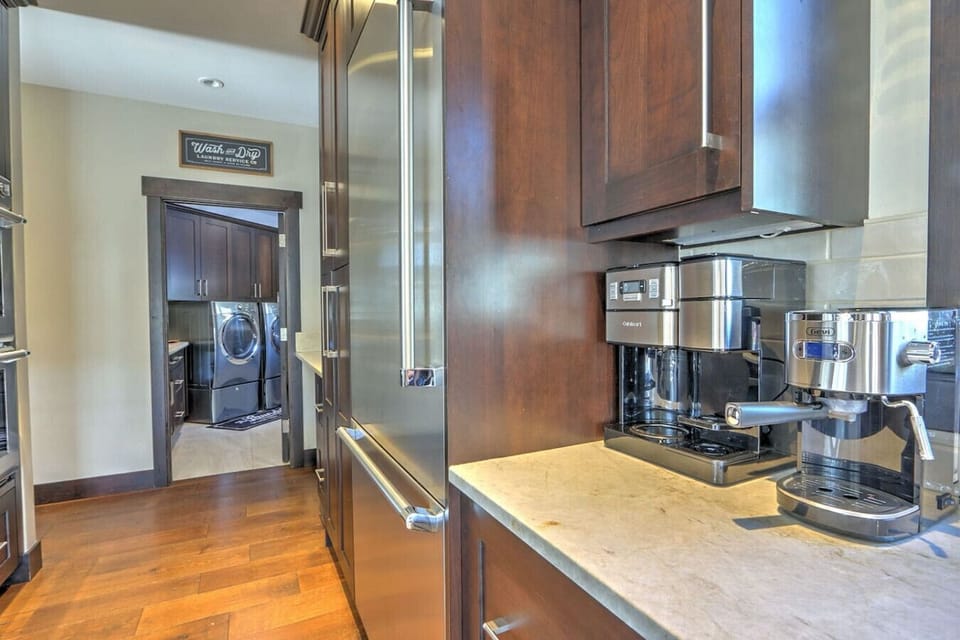 Pristine chef`s kitchen w/ luxury range and hall to laundry & mudroom