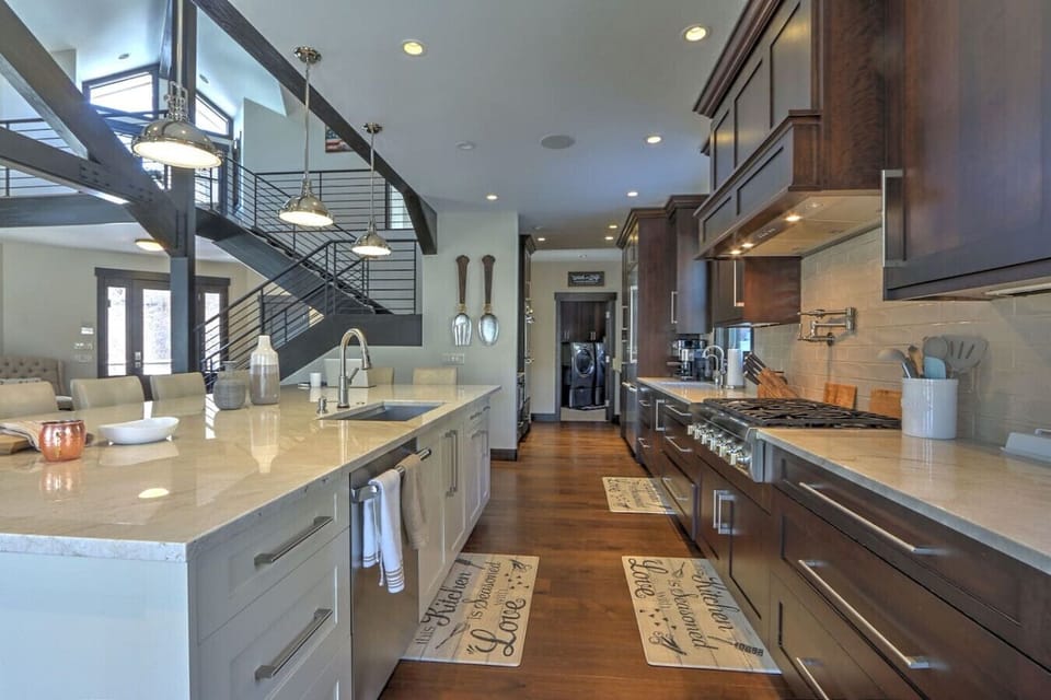 Pristine open concept chef`s kitchen w/ large island and breakfast bar seating
