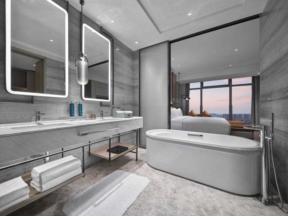 Suite, 1 King Bed | Bathroom | Hair dryer, slippers, towels