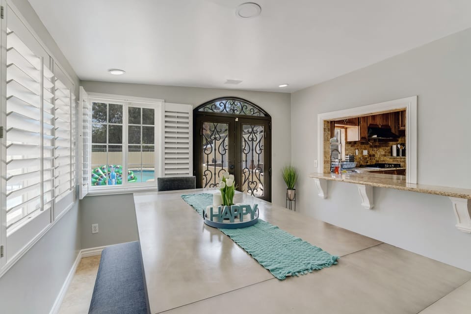 Stylish gray table with chairs and bench, perfect for meals and gatherings.