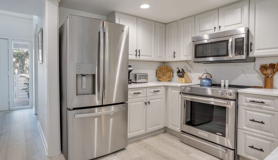 The tile flooring keeps the space cool and practical, while recessed lighting provides even, inviting illumination throughout.