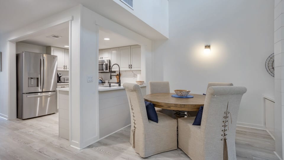 An open pass-through connects the dining area to the kitchen, creating easy flow for serving and conversation.