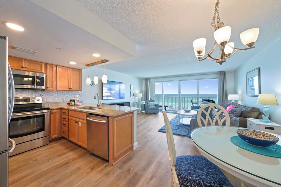 Gather for meals at the dining table just steps from the kitchen in this inviting Cabana Club vacation rental.