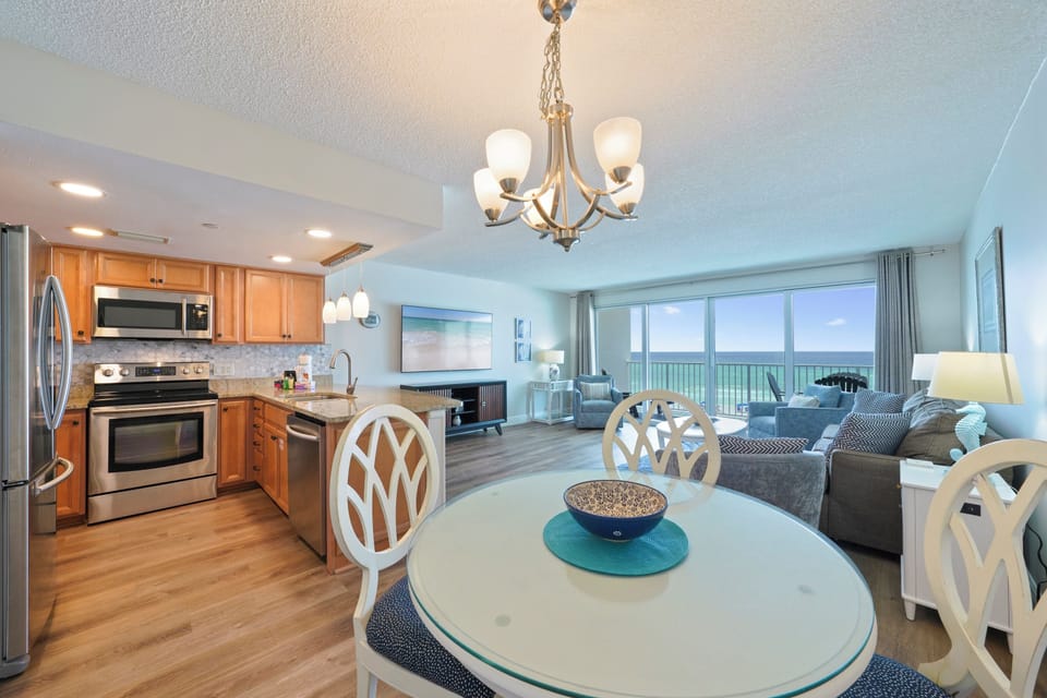 Cabana Club 307 beachfront condo in Destin featuring an open-concept kitchen, dining area, and Gulf-front living room with private balcony overlooking the Emerald Coast.