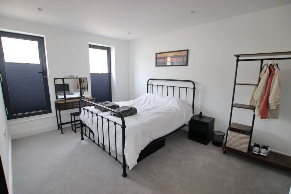 A comfortable room with natural light and a handy desk area.