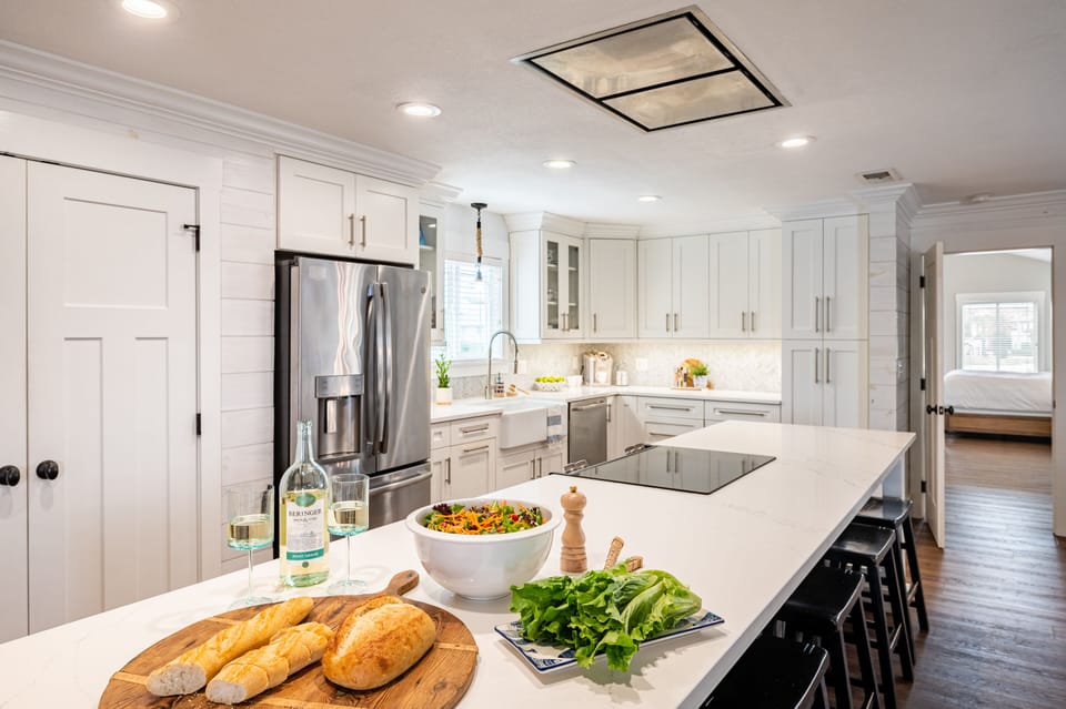 Spacious kitchen with modern appliances and barstool seating.