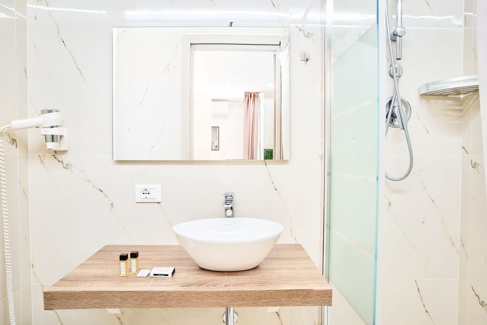 Deluxe Quadruple Room, Multiple Beds | Bathroom | Combined shower/tub, rainfall showerhead, hair dryer, bathrobes