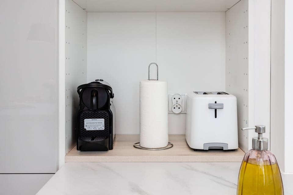 A modern utility corner featuring a washing machine, dryer, and minimalist design.
