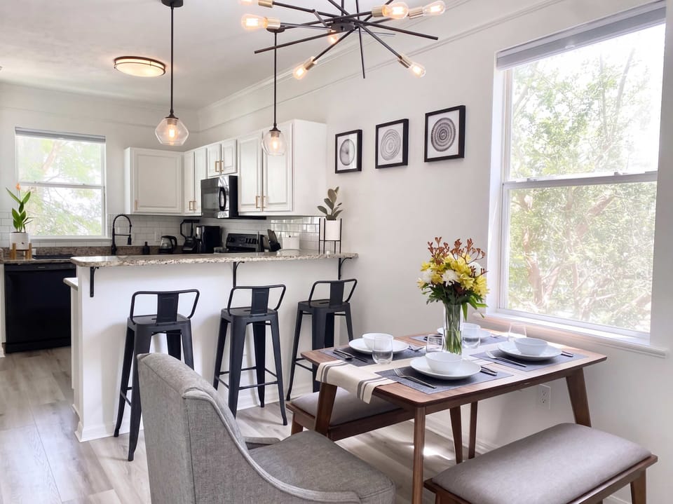 Gather for meals at this open dining space with plenty of natural light and easy access to the kitchen.