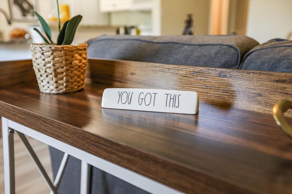 Thoughtful touches like designer lighting and potted plants create a serene, homey environment.