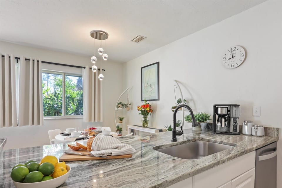 Our open-concept kitchen features stunning stone countertops and all the essentials—from the morning coffee maker to a spacious prep area for dinner.