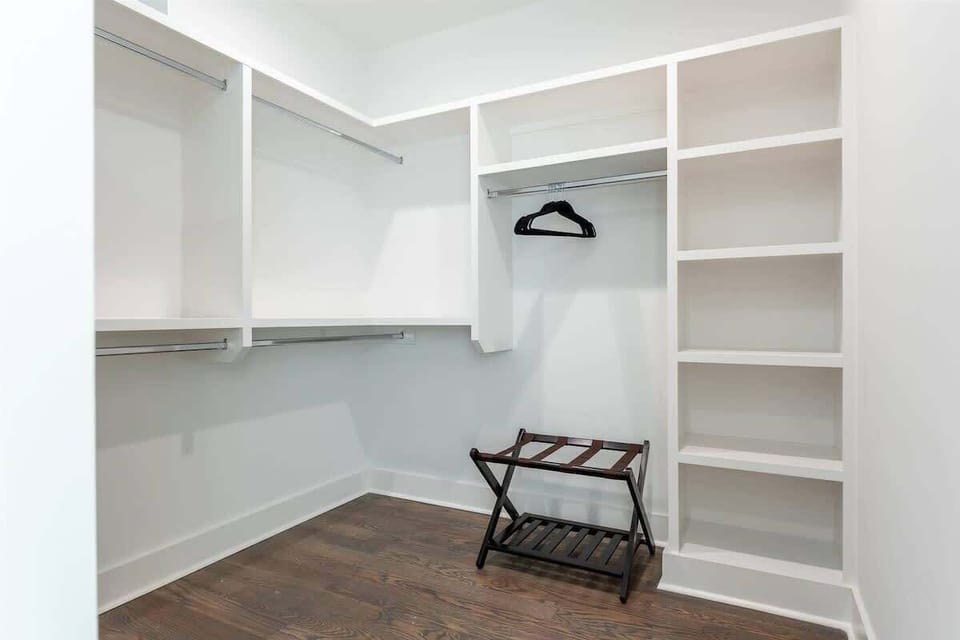 Spacious walk-in closet with built-in shelving, hanging space, and room to easily unpack and organize your stay essentials.