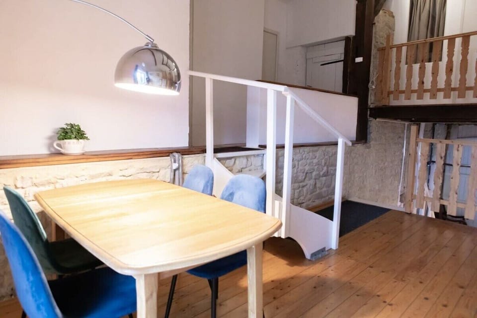 Upstairs landing with a table, cupboard filled with childrens toys, and a bunk bed.
