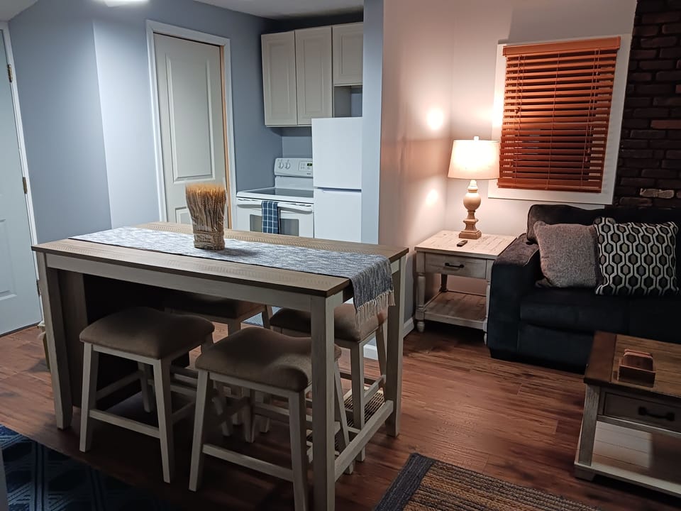 View From Spiral Staircase Viewing Part Of Livingroom & Kitchen & Dinette Set.