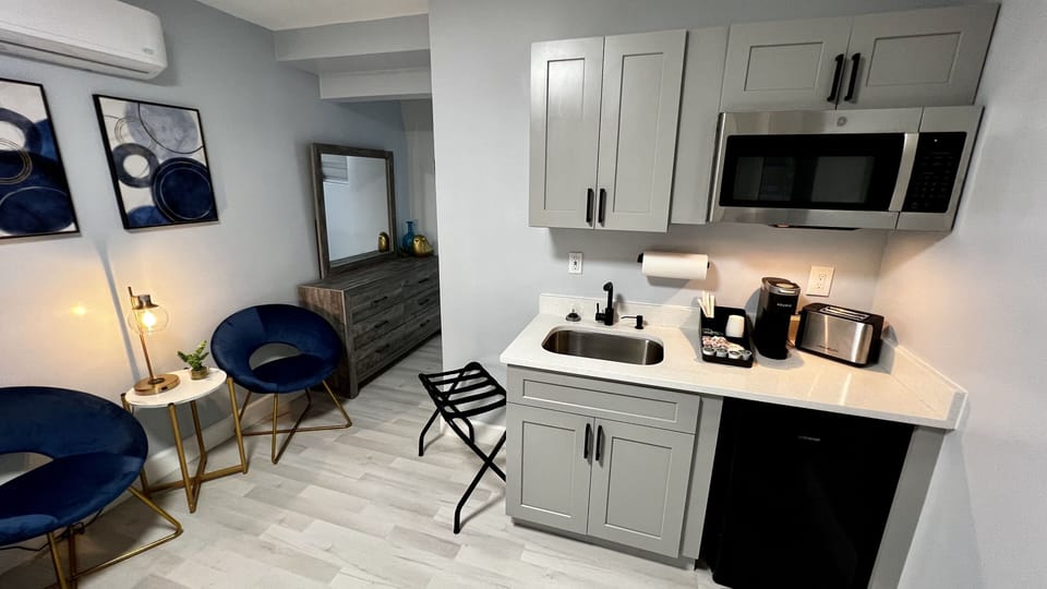 Kitchenette is equipped with mini fridge, microwave, toaster, coffee machine